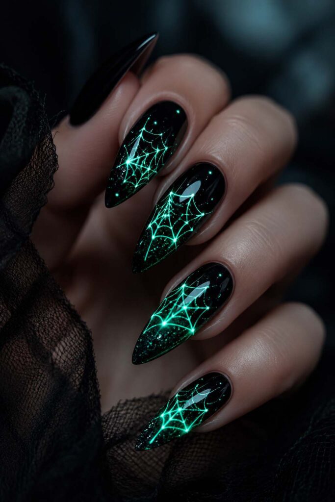 A woman's hand with a Halloween manicure and a phosphorescent glow.